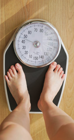 point of view - closeup feet for asian woman measure weight on scale