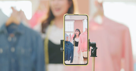 beautiful beautiful asian girl selling fashionable clothes on live streamg at happy and smile atmosphereの写真素材