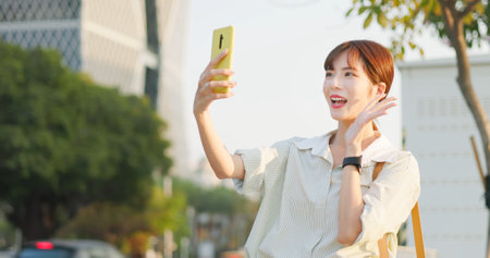 happy asian business woman use smart phone take selfie in cityの写真素材