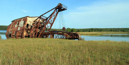 remains of old dredger in bayの写真素材