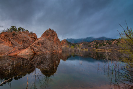 Red rocks in a calm pond.