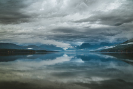 Overcast skies reflected in a calm lake.