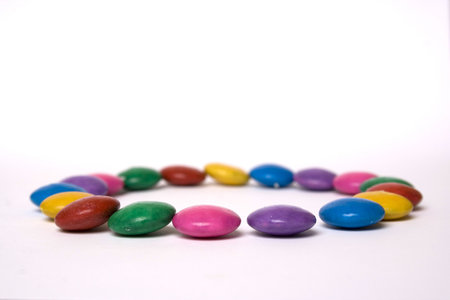 rainbow colored candy, in a circle on white backgroundの写真素材