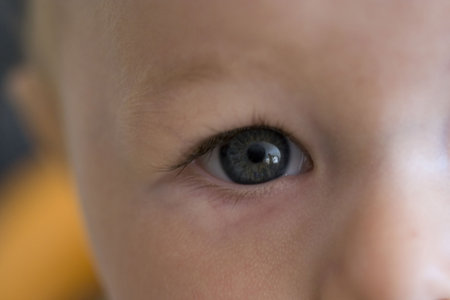 an infants eye, close up with reflection of woman in it.の写真素材