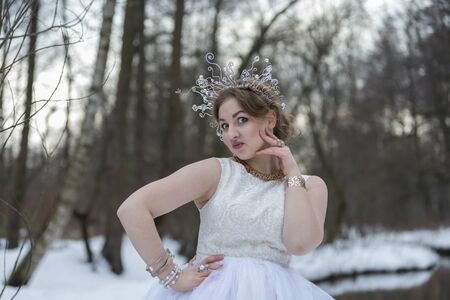 Portrait of a young beautiful woman wearing a Crownの写真素材