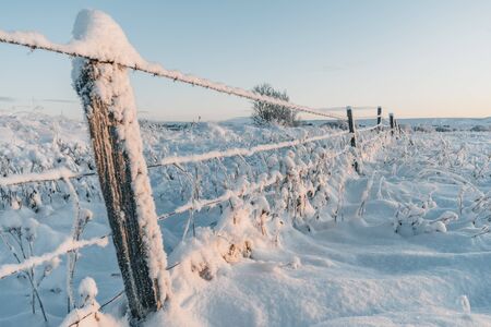 Beautiful winter in Iceland. Landscape covered under a fresh snow during the golden hour of sunset light. A breathtaking natureの写真素材