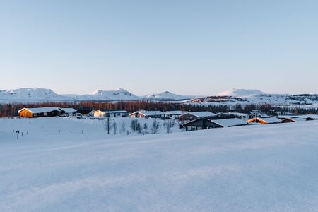 A winter wonderland in Iceland. Photograph shows one of the frozen Icelandic villages during the golden hour. Tourism in Iceland. Visit Iceland any time of the year.の写真素材