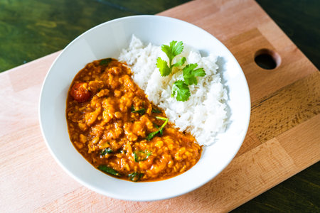 Roasted cauliflower lentil curry vegetarian or vegan food. Flat lay thumbnail photograph of an asian...