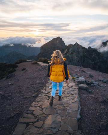 A young adventurous woman traveling and hiking alone in the mountains of Madeira in Portugal. High quality photoの写真素材