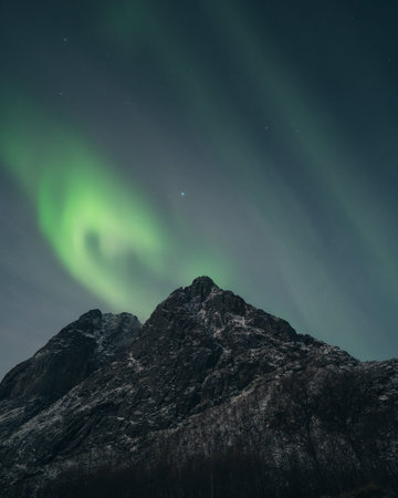 Northern lights known as aurora borealis over the arctic landscape in Norway. High quality photoの写真素材