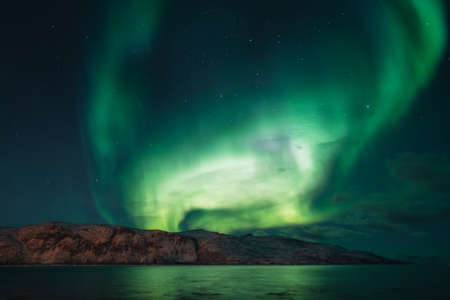Northern lights known as aurora borealis over the arctic landscape in Norway. High quality photoの写真素材