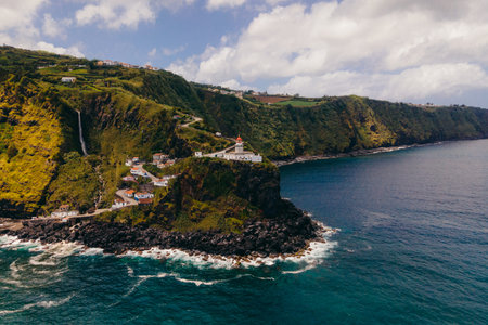 Farol do Arnel is a graceful lighthouse on Sao Miguel Island, Azores, guiding seafarers with its luminous presence and maritime history. High quality photoの写真素材