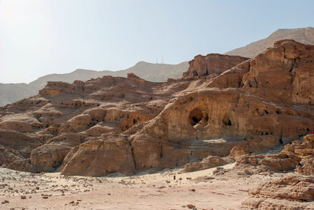 View on the canyon of Timna park from arch made by wind in sandstone of geological formations, Israelの写真素材