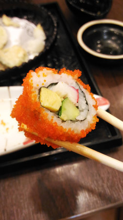 Sushi roll with chopsticks isolated on restaurant restaurantの写真素材