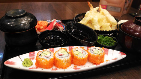 Sushi set on plate with wasabi and marinated ginger on wooden table with soy sauceの写真素材