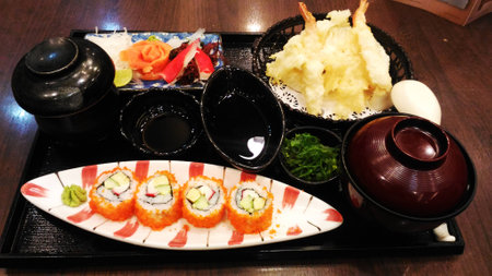 Sushi set on plate with wasabi and marinated ginger on wooden table with soy sauceの写真素材