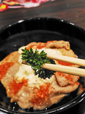 closes up sprinkle vegetables, rice with fried pork topping Cayenne pepperの写真素材