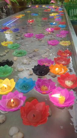 Fire on candle light flower on the waterの写真素材