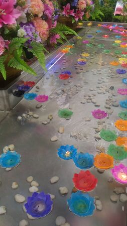 Fire on candle light flower on the waterの写真素材