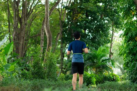 asian young fitness man runner running at the parkの写真素材