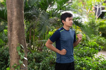 asian young fitness man runner running at the parkの写真素材