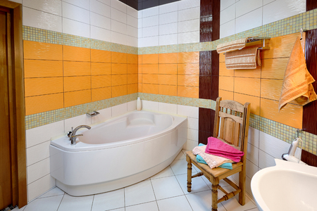 Interior of Bathroom Room with Bath in Orange Tonesの写真素材