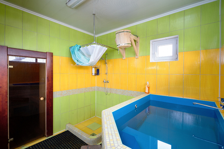 Dressing-room in Sauna with Font, Shower and Wooden Bucket for Pouringの写真素材
