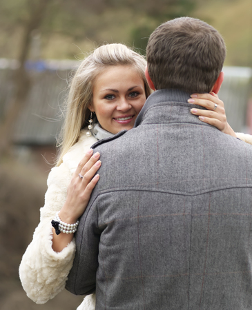 Young Woman Smiling From Behind Her Boyfriendの写真素材