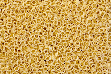 Anelli small thin rings of pasta backgroundの写真素材