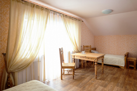 Rural Hostel Room Interior with Wooden Furnitureの写真素材