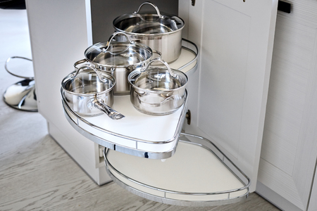 Solution for a kitchen corner storage in a cupboard. A corner unit with pullout shelves for cookwareの写真素材