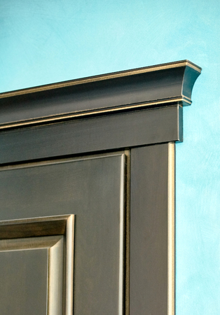 Element of wooden door in frame of ebony black and golden wood carved in classical style on blue plastered wall background close upの写真素材