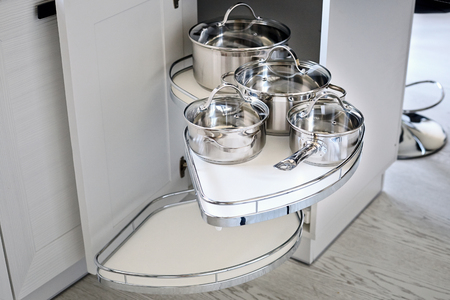 Solution for a kitchen corner storage in cupboard. Corner unit with pullout shelves for cookware.の写真素材
