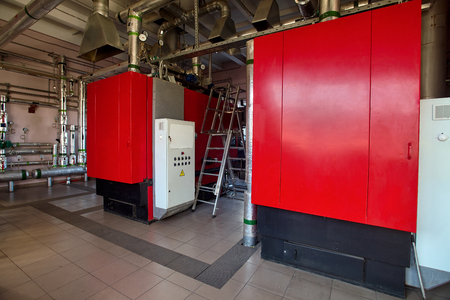 Boiler room working at wood waste. Concept of using recycled materials from garbage to obtain environmentally friendly fuel recovery.の写真素材
