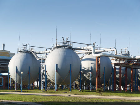 Industrial landscape with view of several ball gasholders with lightning protection and safety valve on modern chemical production.の写真素材