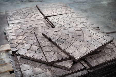 Modern waste sorting and recycling plant, pallet of tiles made out of plastic waste. Concept of preserving environment and preventing pollution by recycling and reusing garbage and waste materials.の写真素材