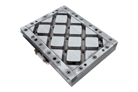 Steel molds or puncheon for environmentally friendly paving slabs made thermo casting from recycled plastics extracted from urban garbage after sorting at waste recycling plant isolated on white.の写真素材