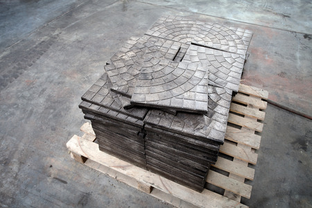 Modern waste sorting and recycling plant, pallet of tiles made out of plastic waste. Concept of preventing pollution by recycling and reusing garbage and waste materials and preserving environment.の写真素材