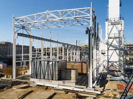 Construction site of modern chemical production in the process of assembling of cryogenic air separation department with metal structures and equipment in containers under clear deep blue sky.の写真素材
