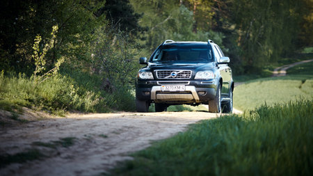 GRODNO, BELARUS - MAY 2015: Volvo XC90 4.4 v8 1st generation restyling 4WD SUV test drive in spring field country road on forest background in Grodno Belarusのeditorial素材