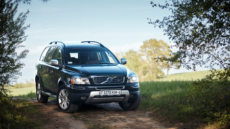 GRODNO, BELARUS - MAY 2015: Volvo XC90 4.4 v8 1st generation restyling 4WD SUV test drive in spring field country road on blur sky background in Grodno Belarusのeditorial素材