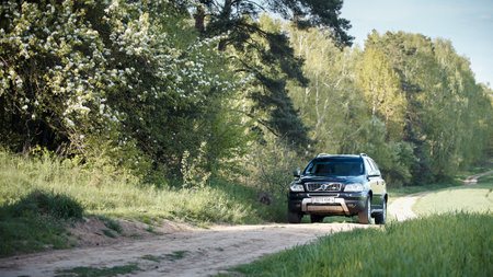 GRODNO, BELARUS - MAY 2015: Volvo XC90 4.4 v8 1st generation restyling 4WD SUV test drive in spring field country road on bloom and blossoms forest background in Grodno Belarusのeditorial素材