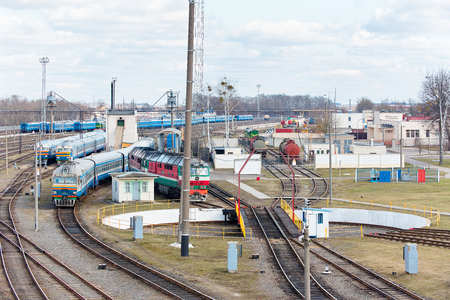 Diesel locomotives and carriages stand in depot near railway turntable.の写真素材