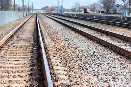 Selective focus railway goes straight ahead at sunny spring daytime to blue haze horizon background with copy space.の写真素材