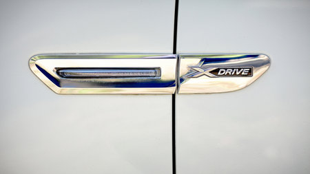 Grodno, Belarus, May 16, 2013: Modern luxury BMW 750Li XDrive  xdrive metal logo selective focus close-up front view.のeditorial素材