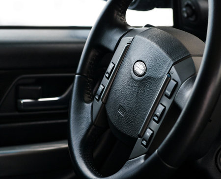 Grodno, Belarus, December 2012: Land Rover Range Rover Sport 5.0L V8 Supercharged. Steering wheel of modern luxury car class prestige car made of leather with cruise control buttons and media management system.のeditorial素材