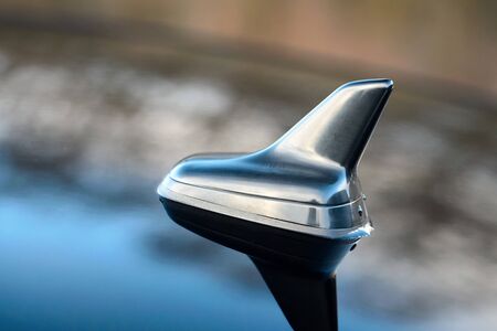 GPS antenna shark fin shape on a roof of german car for radio navigation system. Outdoor car radio antenna with drops of water.の写真素材