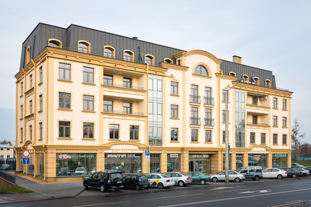GRODNO, BELARUS - NOVEMBER 2019: example of modern architecture of eastern Europe residential building in Belarus Grodno stores inscriptions translation: children's club, Men's clothing, Pharmacy.のeditorial素材