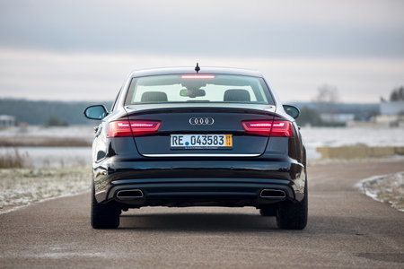 GRODNO, BELARUS - DECEMBER 2019: Audi A6 4G, C7 2.0 TDI 190 Hp 2016 facelift rear outdoors on winter road during testdrive with forest on background.のeditorial素材