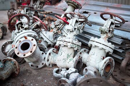 Old valves taps shutoff flaps vents of chemical production dismantled. Concept of modernization and updating of chemical plants in order to increase efficiency and safety.の写真素材
